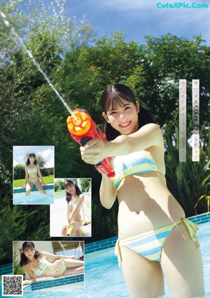 A woman in a bikini holding a water gun in a pool.