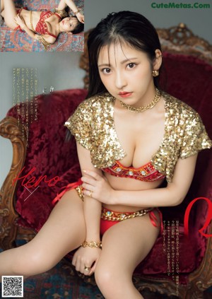 A woman in a red bikini laying on a rug.
