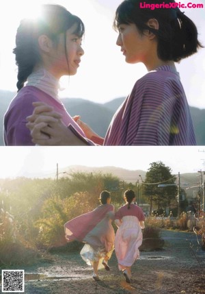 A couple of women standing next to each other near a body of water.