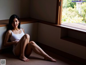 A woman sitting on the steps of a building.