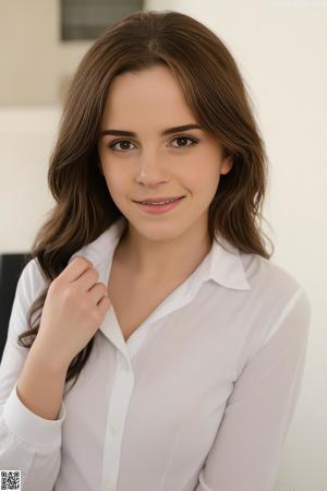 A beautiful young woman with long brown hair posing for the camera.