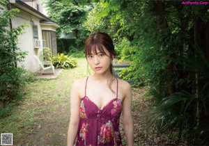 A woman in a striped bikini posing for a picture.