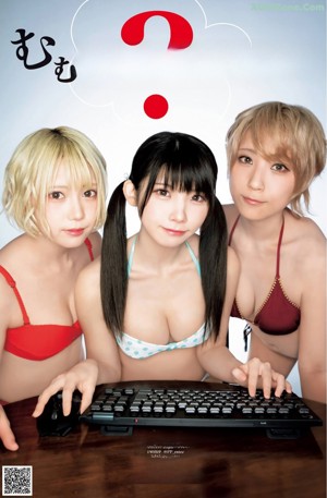 A group of three women sitting next to each other in front of a computer.