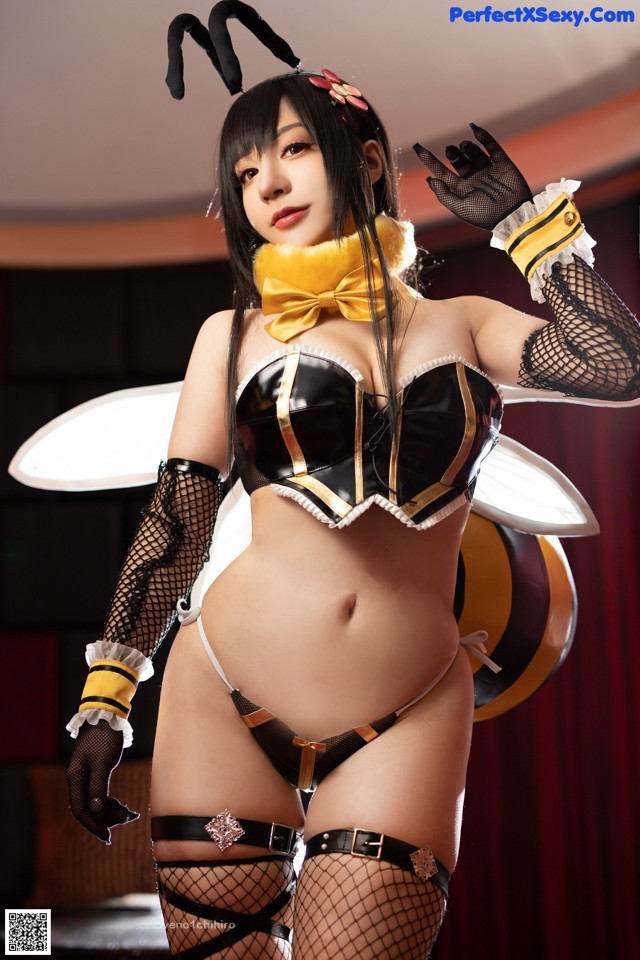 A woman dressed as a bee in a black and yellow outfit.