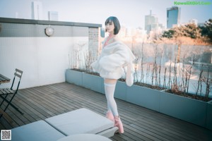 A woman in a bunny costume is posing for a picture.