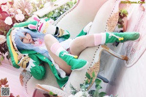 A woman sitting on top of a bed holding a stuffed animal.