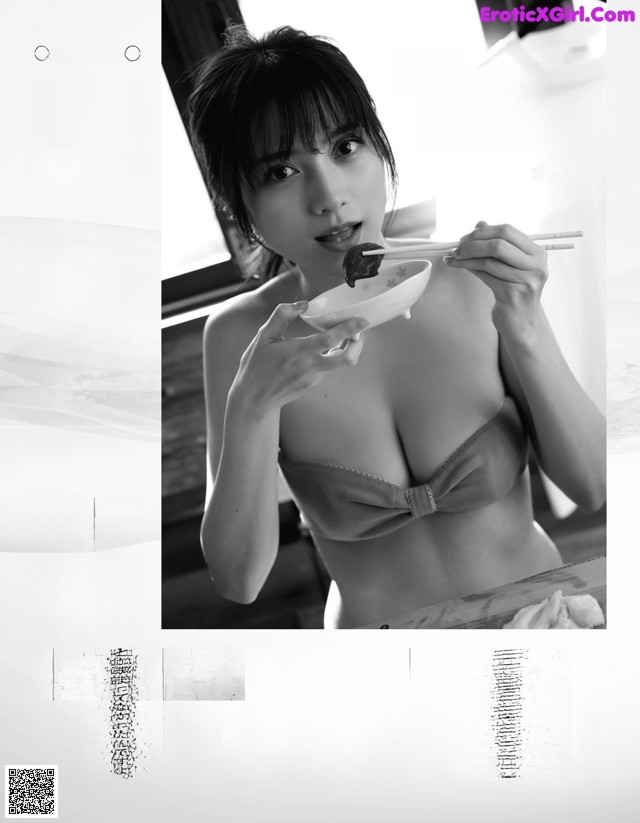 A woman in a bikini eating a bowl of food.