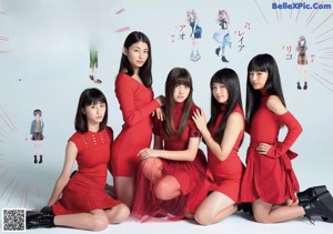 A group of young women sitting on top of a roller coaster.