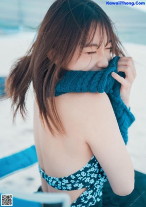 A woman with long brown hair is posing for a picture.