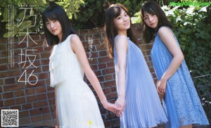 A group of young women sitting on top of a white couch.